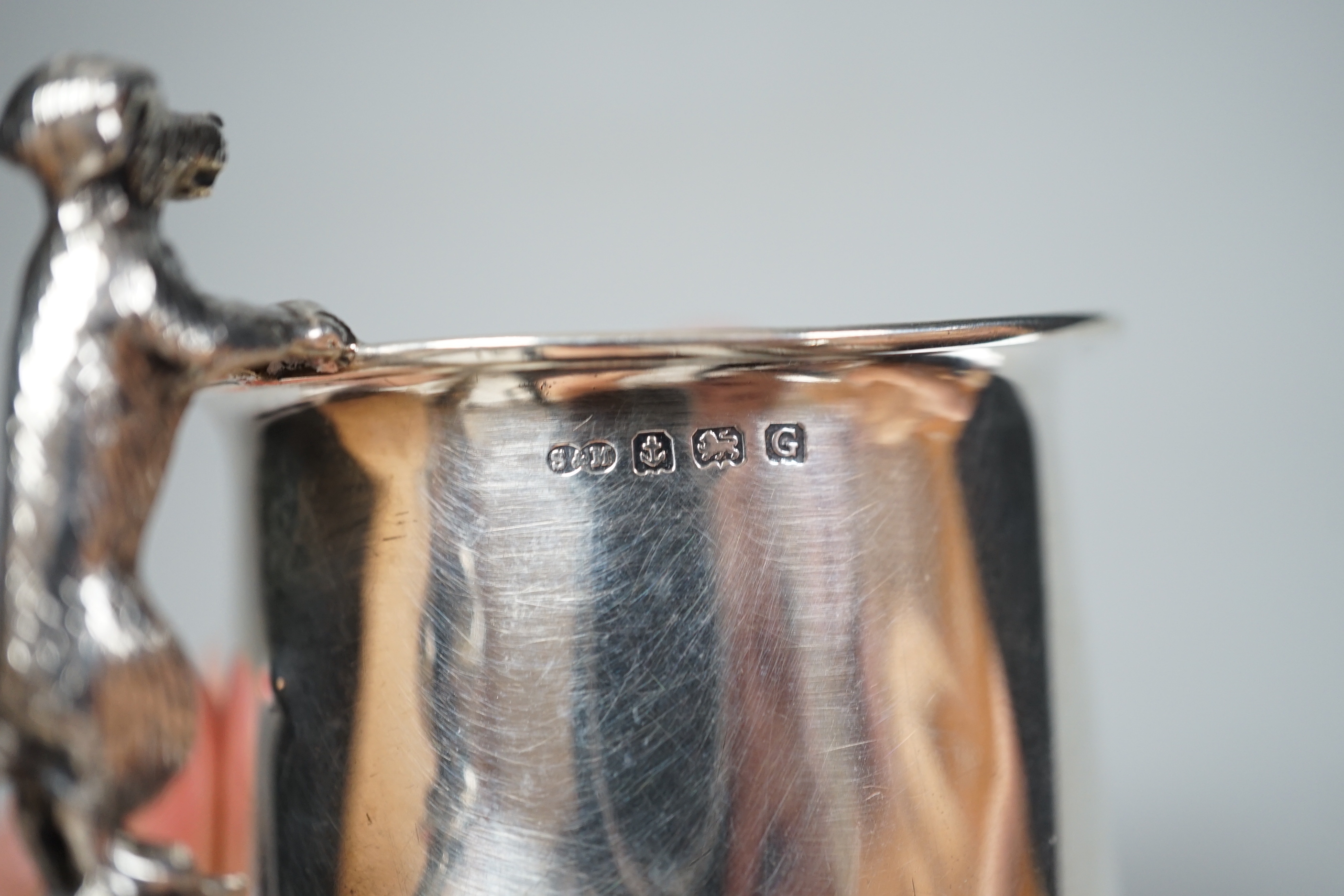 A George V silver christening mug, with dog handle, Sanders & Mackenzie, Birmingham, 1931, 77mm, together with a lady's 9ct gold Vertex manual wind wrist watch, no strap and a Lorus nurses watch.